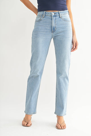 Light blue jeans worn by a person on a white background