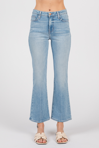 A pair of light blue denim cropped flare jeans with a creased line design, displayed on a model without showing the upper part of the body.