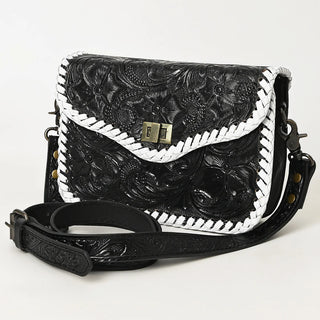 Black leather handbag with white floral embroidery on a light gray background