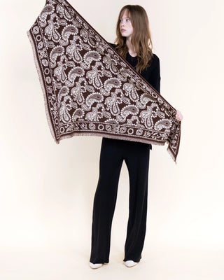 Brown triangular scarf with white paisley pattern and fringe edges