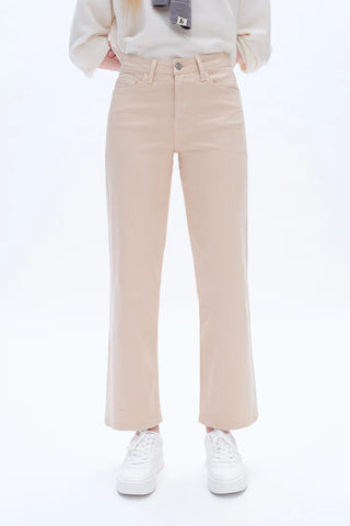 Beige pants worn by a person on a white background