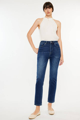 Woman wearing blue jeans and a white top on a white background