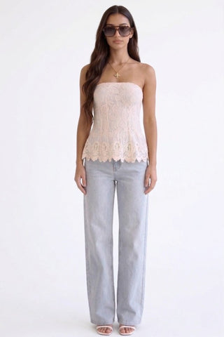 Woman wearing crochet tube top with jeans
