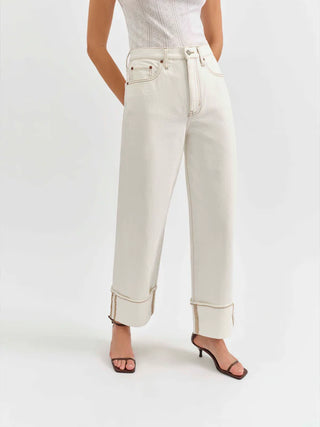 White pants worn by a person on a white background