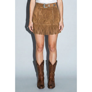 Woman wearing suede fringe skirt with boots