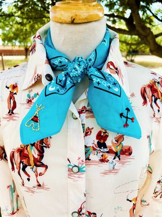 Mannequin wearing a shirt with cowboy print and a blue bandana