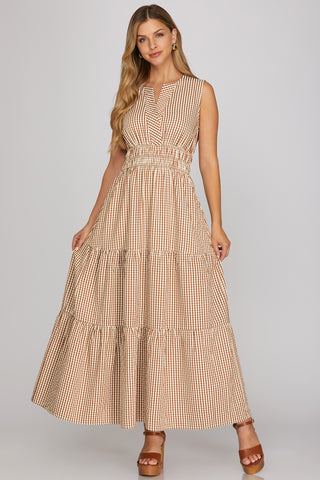 Woman wearing a beige checkered dress on a gray background