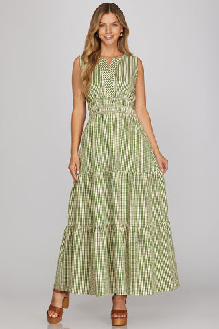 Woman wearing a green checkered dress on a gray background