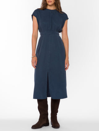 Navy blue midi dress with cap sleeves, elastic waist, and front slit worn with brown boots