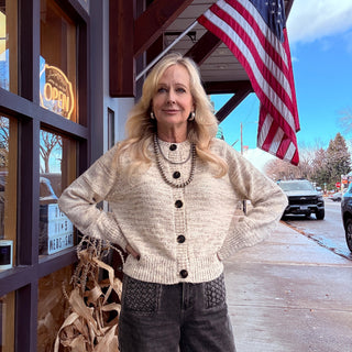 Person standing in front of a building with an American flag