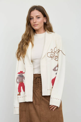Cream knit cardigan with cowboy jacquard sleeves and cursive Howdy embroidery