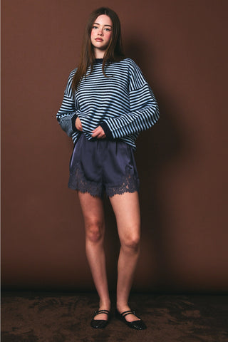 Midnight blue satin mid-rise shorts with lace trim hem and elastic waist