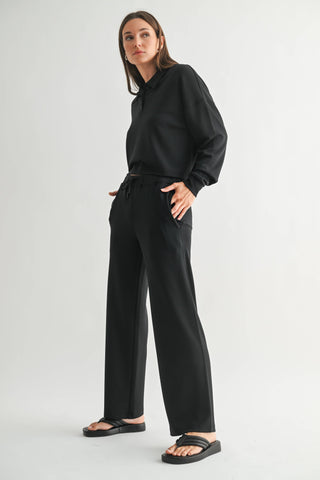 Woman wearing a black outfit on a white background
