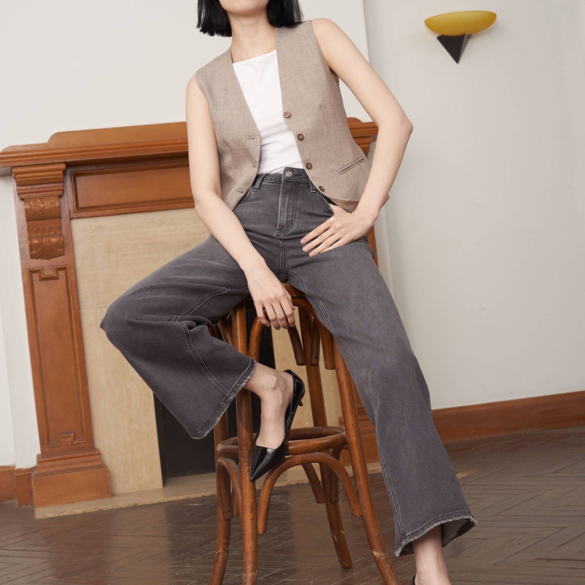 Person wearing gray wide-leg jeans on a white background