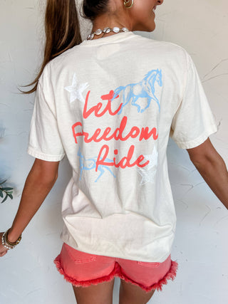 Person wearing a white t-shirt with 'Let Freedom Ride' text and horse graphic.