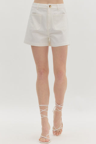 White denim shorts worn by a person on a white background