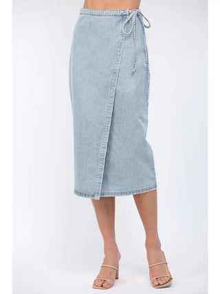 Light blue denim skirt worn by a person on a white background