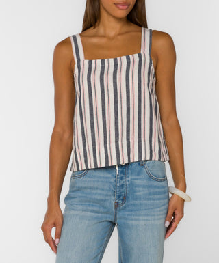 Woman wearing a striped tank top and jeans on a white background