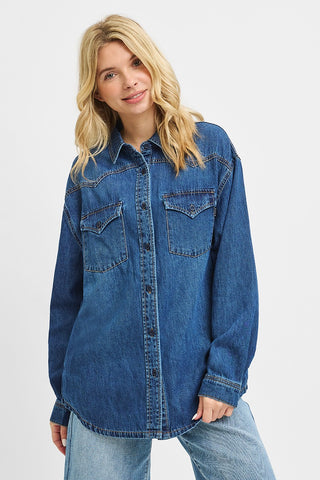 Woman wearing a blue denim shirt on a white background