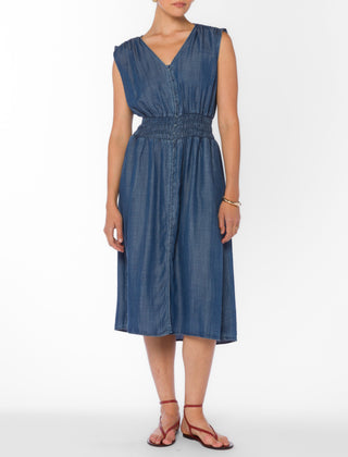 Woman wearing a blue denim dress on a white background