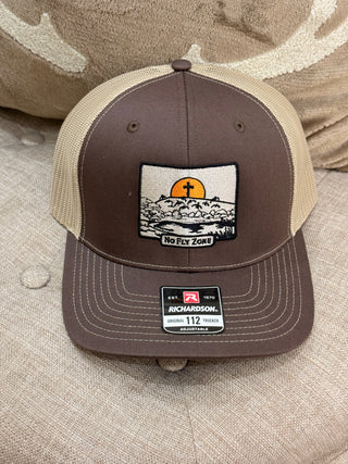 Brown and beige cap with a patch on a textured surface