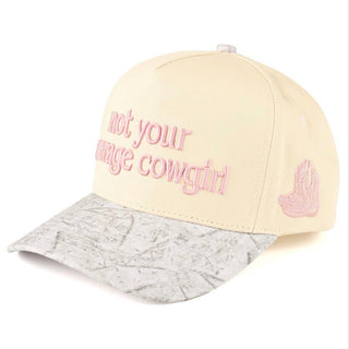Cap with 'not your average cowgirl' text and pink logo on a white background