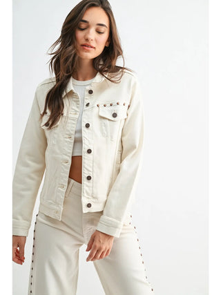 Woman wearing a cream denim jacket on a white background