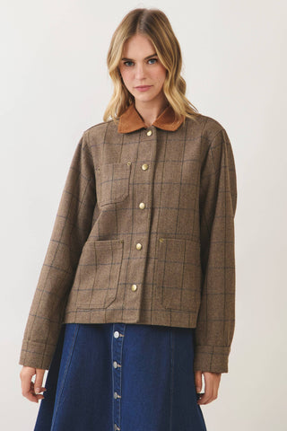 Model wearing a brown plaid chore jacket with gold snap buttons and contrast collar