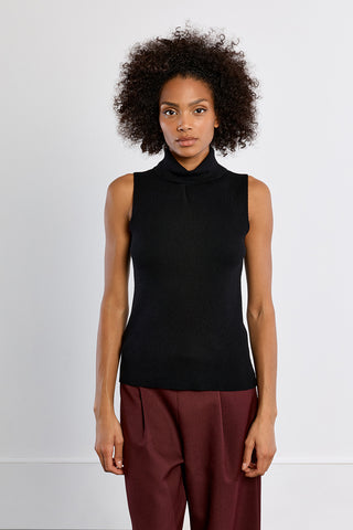 Black sleeveless turtleneck knit sweater with slim fit, paired with burgundy trousers