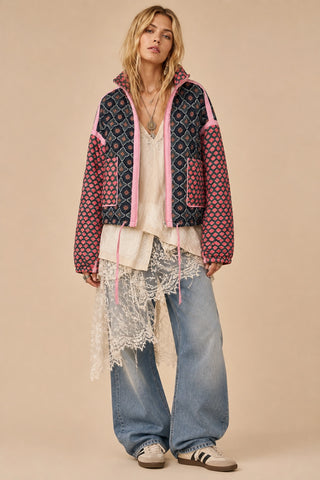 Woman wearing patchwork jacket and denim pants