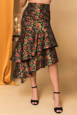 Floral tiered skirt worn by a person on a beige background