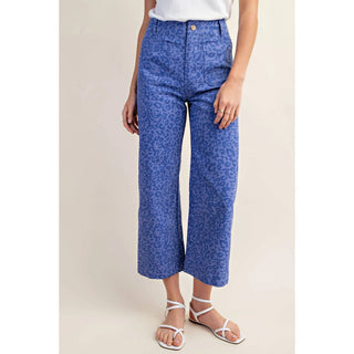 A pair of cropped ankle-length pants with a leopard print pattern. The pants are blue, and the texture of the print is visible.