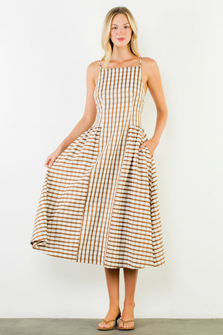 Woman wearing a checkered dress against a white background