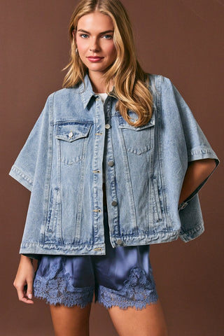 Woman wearing a denim jacket and shorts against a brown background