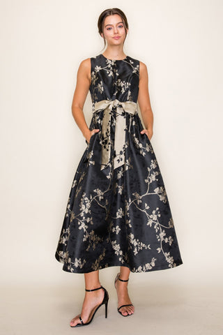 Woman in black and gold evening dress