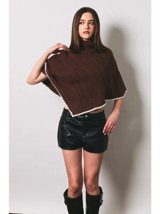 Brown cable knit turtleneck poncho with cream crochet trim edges