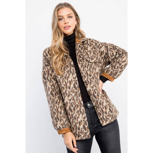 Woman wearing a leopard print jacket on a white background