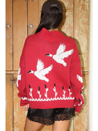 Red knit zip-up cardigan with white flying duck and cattail pattern