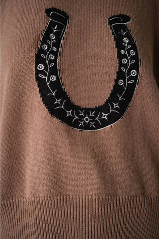 Mocha knit sweater with black embroidered horseshoe patch featuring floral vine details