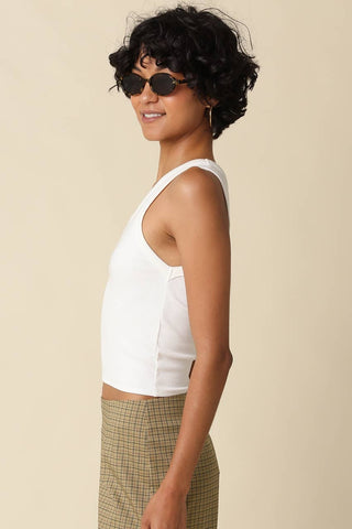 White ribbed scoop neck sleeveless crop tank top, side view on model