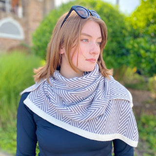 Grey and ivory chevron knit poncho scarf with white border trim and gold side buttons
