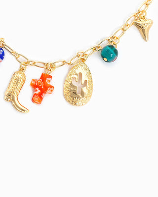 Gold chain necklace with western charms: cowboy boot, cactus medallion, cross bead, shark tooth, teal bead