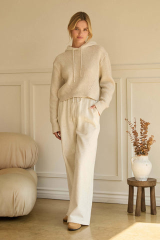 Cream wide-leg soft knit drawstring pants with relaxed silhouette and fluid drape