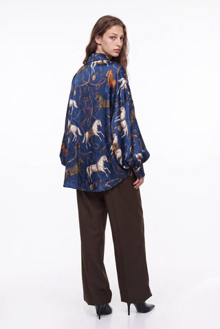 Oversized blue silky shirt with equestrian horse print and puff sleeves, back view