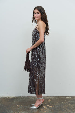 Model wearing a dark brown large sequin spaghetti strap slip midi dress, side view