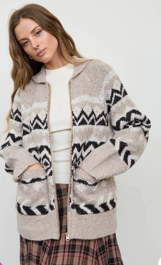 Model wearing an open zip-up knit cardigan with geometric Fair Isle pattern and collared neckline