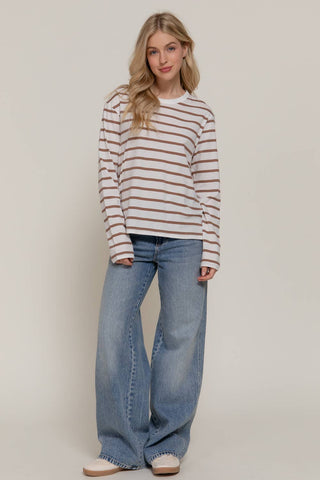 White and brown striped long sleeve crew neck tee paired with wide-leg jeans