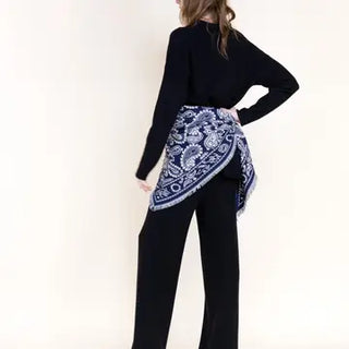 Navy blue and white paisley triangular scarf with fringe tied at waist