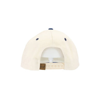 Back view of cream and navy snapback baseball cap with C.C label
