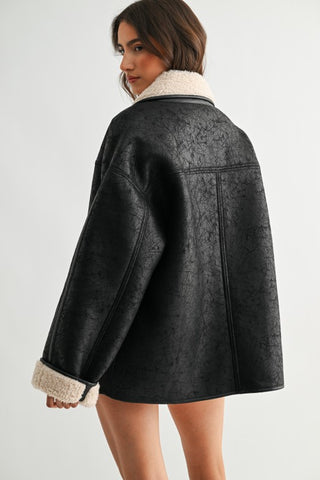 Black crinkled faux leather reversible jacket with cream sherpa collar and cuffs